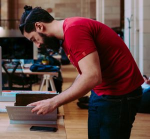 Busy man skimming a book for information